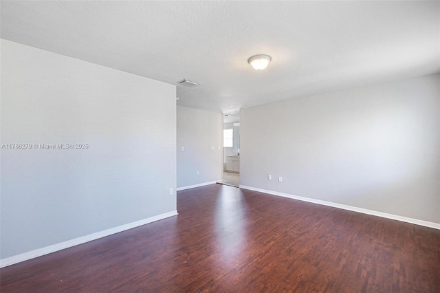 16122 SW 104th Ter, Miami, FL 33196 - unfurnished room with baseboards, wood finished floors, and visible vents
