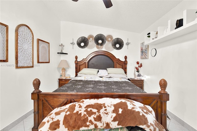 tiled bedroom featuring vaulted ceiling, a textured ceiling, baseboards, and ceiling fan