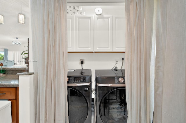 clothes washing area with washer and clothes dryer