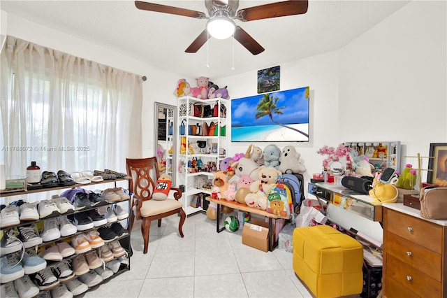 interior space with a ceiling fan and light tile patterned floors