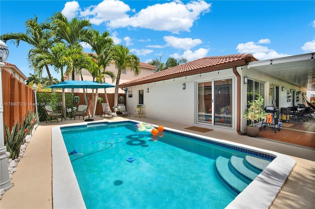view of swimming pool with a fenced backyard, a patio, and a fenced in pool