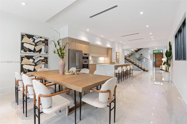 dining room featuring stairway, baseboards, visible vents, and recessed lighting