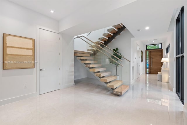 entryway with baseboards, recessed lighting, and stairs