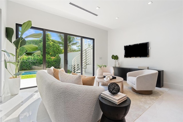 living area with recessed lighting, visible vents, and tile patterned floors