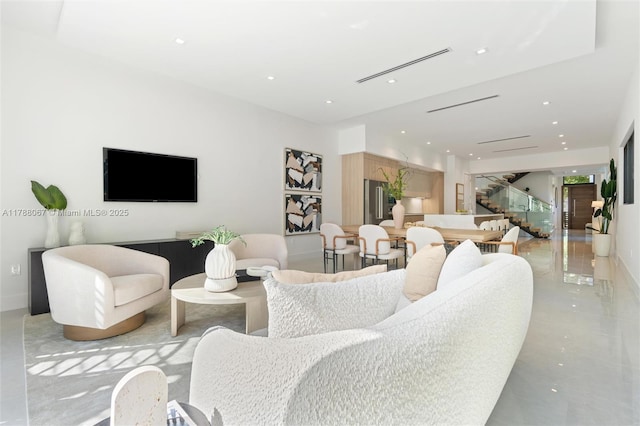 living room featuring stairs and recessed lighting