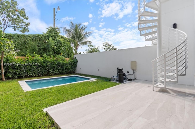 view of pool with a yard, a fenced in pool, a patio, and fence