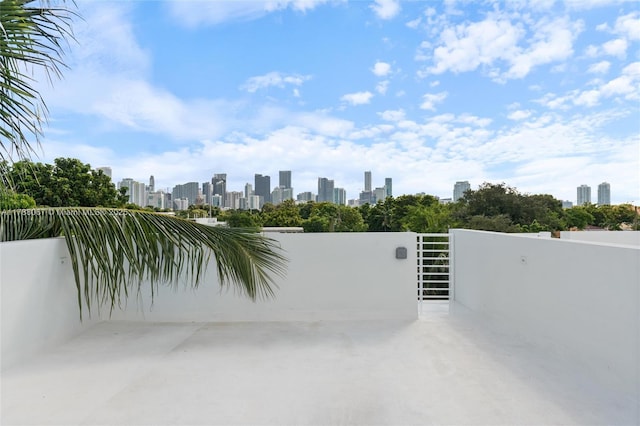view of patio / terrace featuring a city view and a gate
