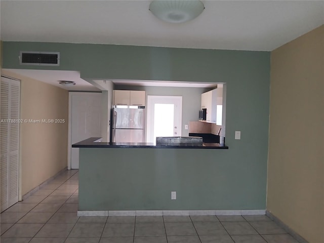 5950 Del Lago Cir Unit 112, Sunrise, FL 33313 - kitchen featuring appliances with stainless steel finishes, dark countertops, white cabinets, and a peninsula