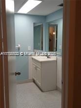 bathroom with a skylight, vanity, and tile patterned floors