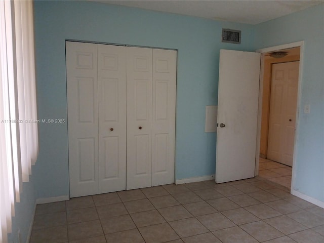 5950 Del Lago Cir Unit 112, Sunrise, FL 33313 - unfurnished bedroom with light tile patterned floors and a closet