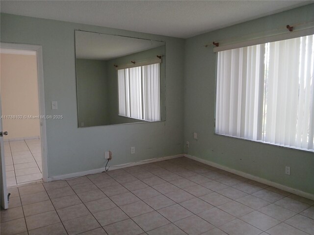 5950 Del Lago Cir Unit 112, Sunrise, FL 33313 - spare room with light tile patterned floors and baseboards