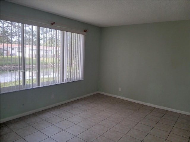 5950 Del Lago Cir Unit 112, Sunrise, FL 33313 - empty room featuring a textured ceiling and light tile patterned floors