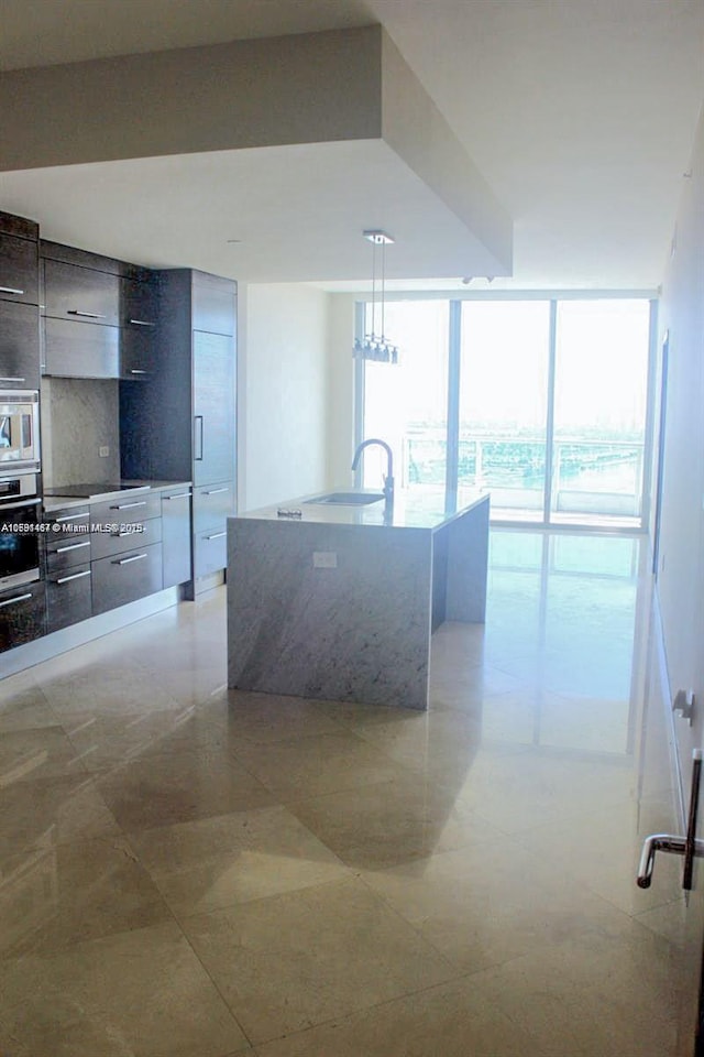 900 Biscayne Blvd Unit 3803, Miami, FL 33132 - kitchen featuring a sink, modern cabinets, a wall of windows, appliances with stainless steel finishes, and hanging light fixtures