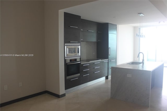900 Biscayne Blvd Unit 3803, Miami, FL 33132 - kitchen with light countertops, a sink, modern cabinets, pendant lighting, and appliances with stainless steel finishes