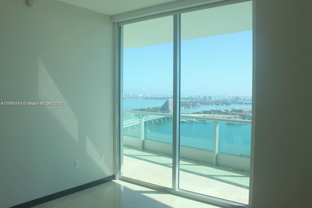 900 Biscayne Blvd Unit 3803, Miami, FL 33132 - empty room with floor to ceiling windows, a city view, a water view, and baseboards