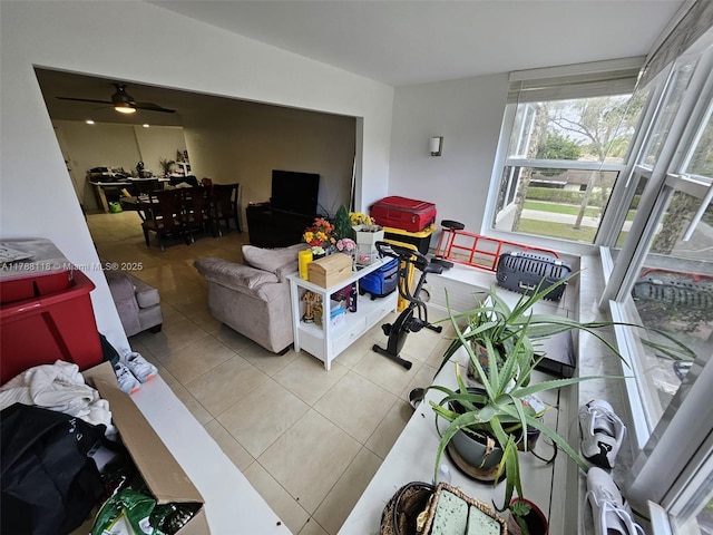 living room featuring tile patterned floors and a ceiling fan