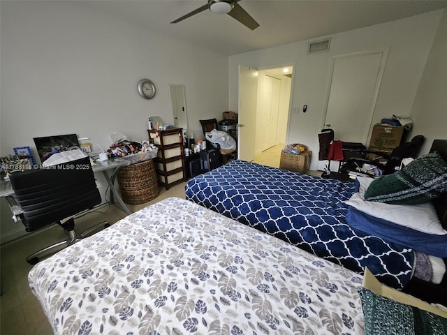 bedroom featuring a ceiling fan, visible vents, and carpet