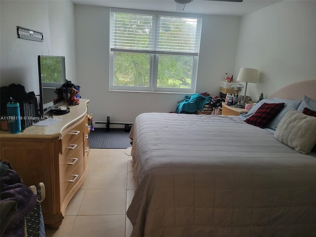 bedroom with baseboard heating and light tile patterned floors