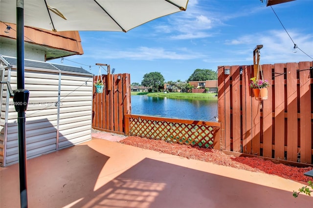 11914 SW 12th Ct, Davie, FL 33325 - view of patio / terrace with a water view and fence