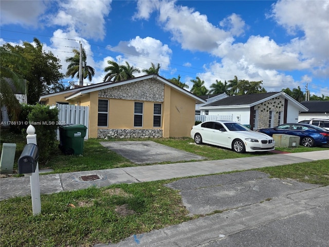 13061 SW 56th Ter, Miami, FL 33183 - bungalow-style house with a front yard, stone siding, stucco siding, and fence