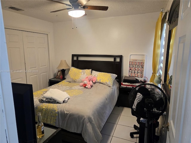 13061 SW 56th Ter, Miami, FL 33183 - bedroom featuring tile patterned floors, a closet, visible vents, a ceiling fan, and a textured ceiling