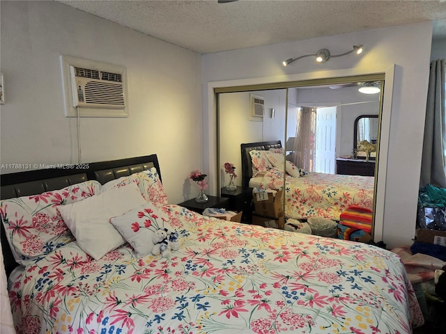 13061 SW 56th Ter, Miami, FL 33183 - bedroom featuring a wall mounted air conditioner, a textured ceiling, and a closet