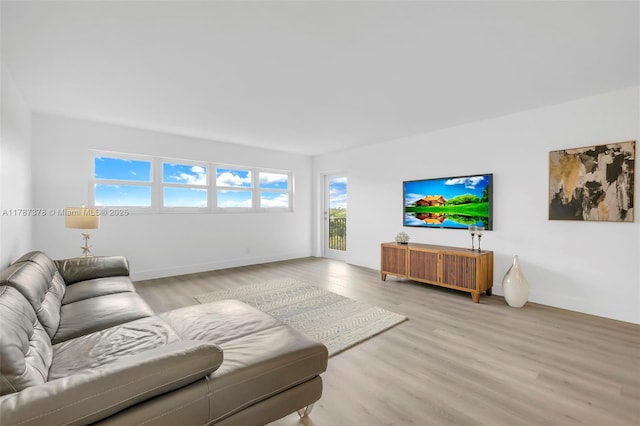 living room with light wood-type flooring and baseboards
