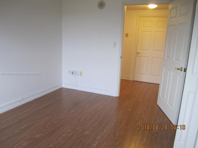 3500 Coral Way Unit 903, Miami, FL 33145 - spare room with baseboards and dark wood-style floors