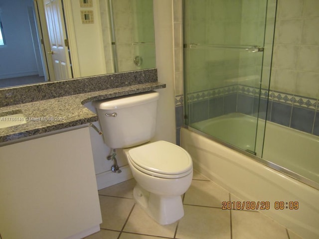 3500 Coral Way Unit 903, Miami, FL 33145 - bathroom with bath / shower combo with glass door, tile patterned floors, vanity, and toilet