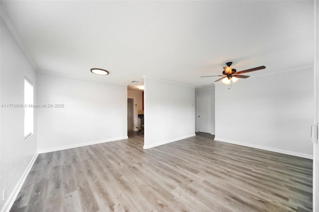 621 Hudson Rd, West Palm Beach, FL 33405 - unfurnished living room with wood finished floors, a ceiling fan, baseboards, and ornamental molding