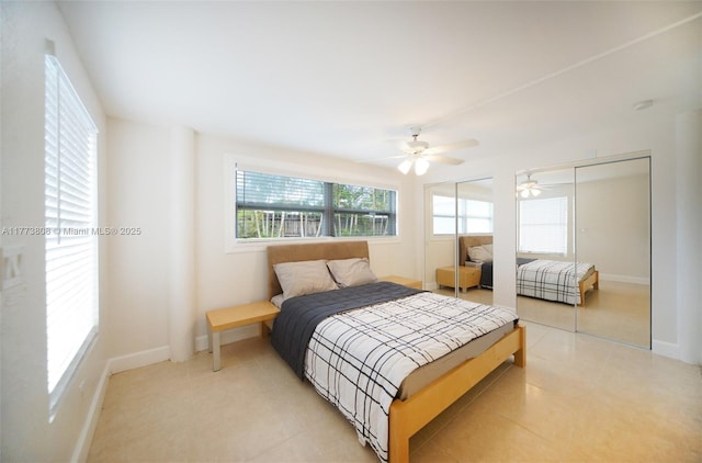 621 Hudson Rd, West Palm Beach, FL 33405 - bedroom featuring multiple closets, baseboards, and ceiling fan