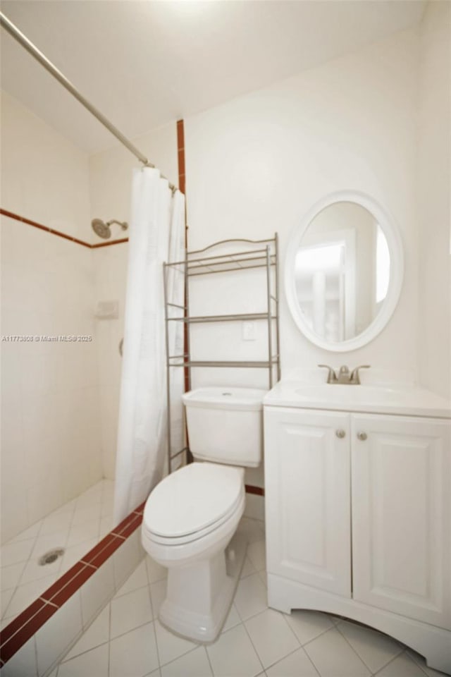 621 Hudson Rd, West Palm Beach, FL 33405 - full bathroom featuring tiled shower, vanity, tile patterned floors, and toilet