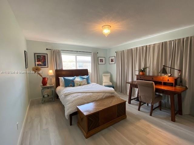 bedroom featuring light wood-style flooring and baseboards