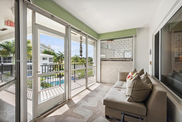 sunroom featuring carpet and a healthy amount of sunlight