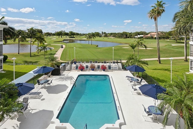 pool featuring golf course view, a lawn, a patio, and a water view