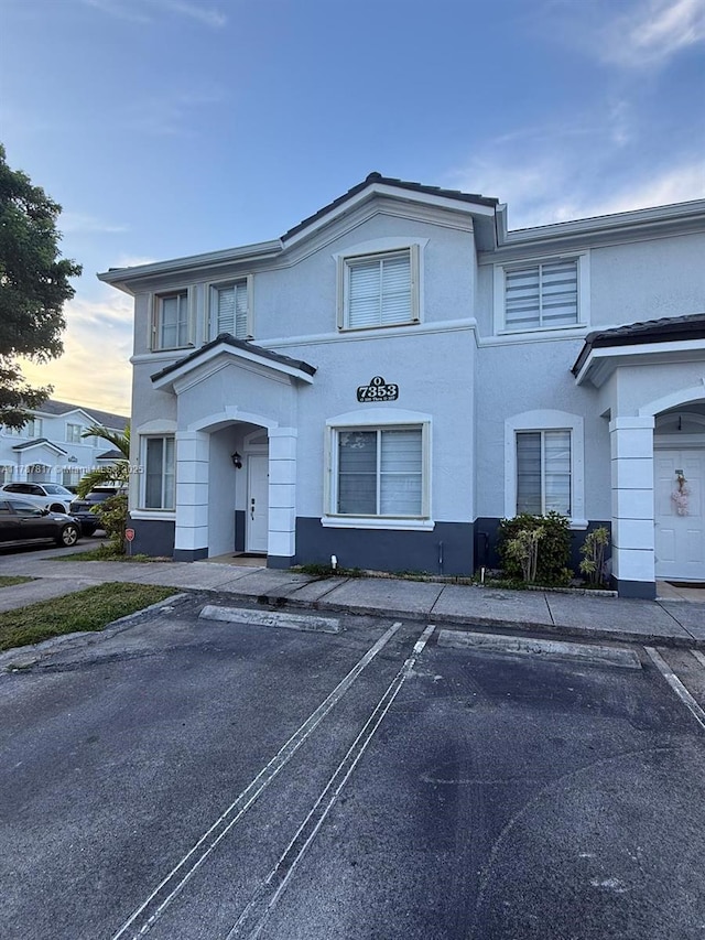 7353 NW 174th Ter Unit 107, Hialeah, FL 33015 - townhome / multi-family property with stucco siding and uncovered parking