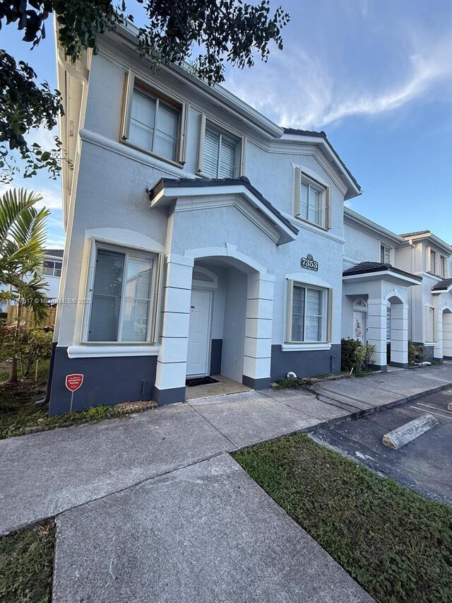 7353 NW 174th Ter Unit 107, Hialeah, FL 33015 - townhome / multi-family property with stucco siding and uncovered parking