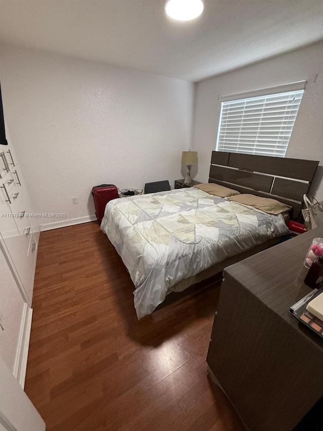 7353 NW 174th Ter Unit 107, Hialeah, FL 33015 - bedroom with wood finished floors and baseboards