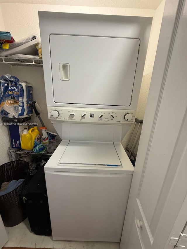 7353 NW 174th Ter Unit 107, Hialeah, FL 33015 - laundry room featuring estacked washer and dryer and a textured wall