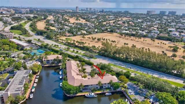 birds eye view of property featuring a city view and a water view