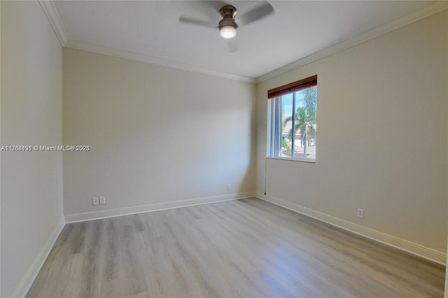 spare room with ceiling fan, baseboards, wood finished floors, and ornamental molding
