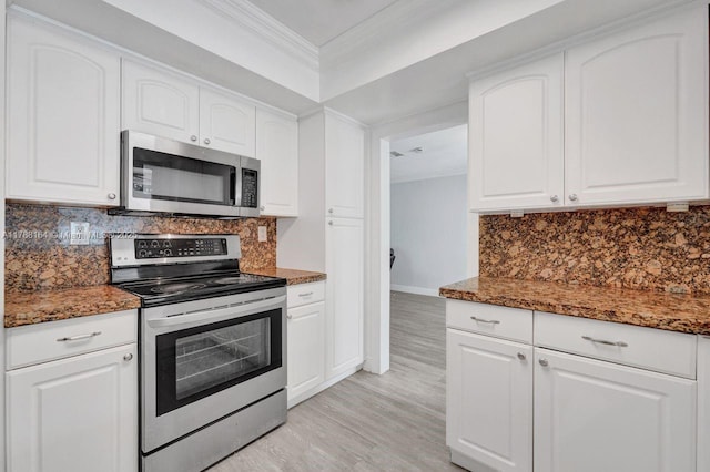 5031 SW 88th Ter, Cooper City, FL 33328 - kitchen featuring appliances with stainless steel finishes, ornamental molding, dark stone countertops, and light wood finished floors