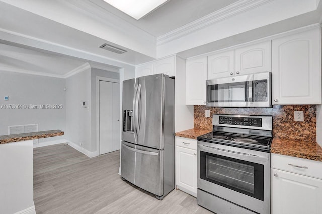 5031 SW 88th Ter, Cooper City, FL 33328 - kitchen featuring appliances with stainless steel finishes, ornamental molding, light wood-style floors, white cabinets, and tasteful backsplash