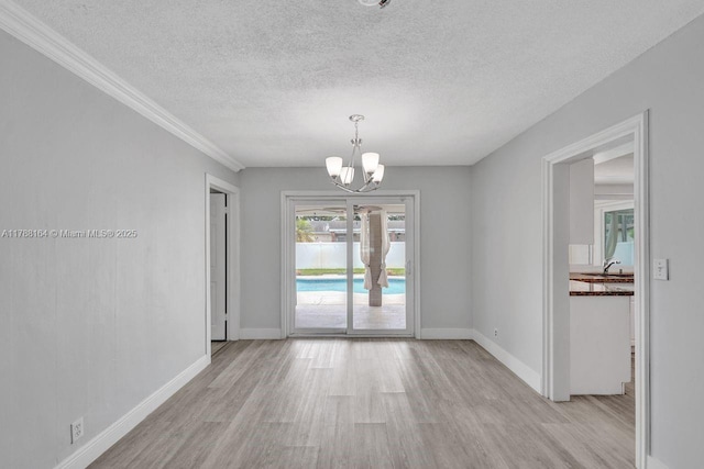 5031 SW 88th Ter, Cooper City, FL 33328 - unfurnished dining area with light wood-type flooring, a chandelier, a textured ceiling, and crown molding