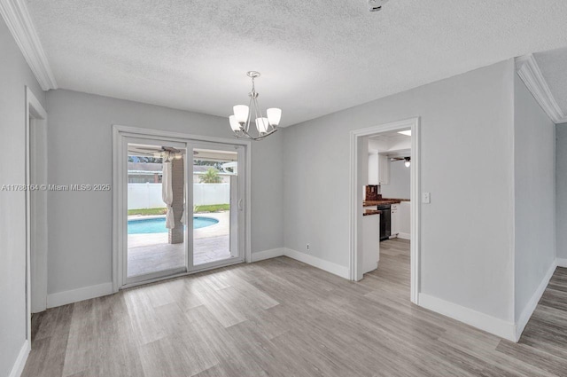 5031 SW 88th Ter, Cooper City, FL 33328 - unfurnished room featuring light wood-type flooring, a chandelier, and a textured ceiling