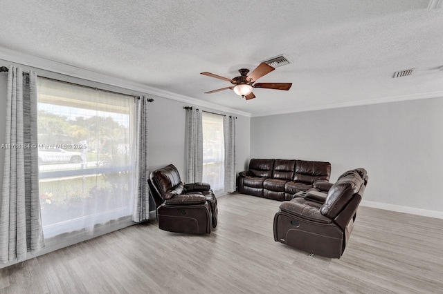 5031 SW 88th Ter, Cooper City, FL 33328 - living room featuring ornamental molding, wood finished floors, ceiling fan, a textured ceiling, and healthy amount of natural light