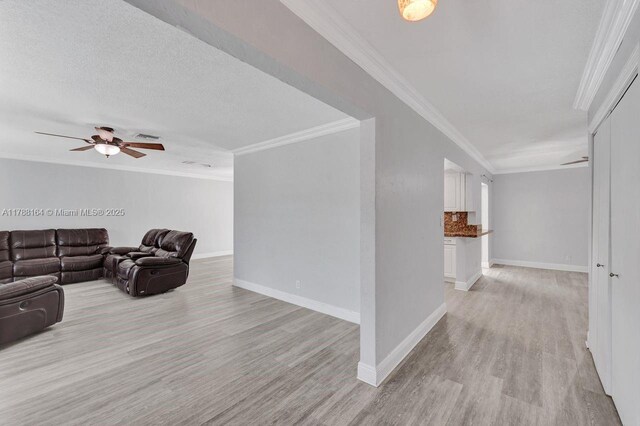 5031 SW 88th Ter, Cooper City, FL 33328 - living room featuring light wood-style floors, ceiling fan, and ornamental molding