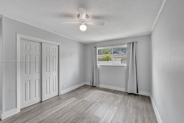 5031 SW 88th Ter, Cooper City, FL 33328 - unfurnished bedroom featuring wood finished floors, a textured ceiling, a closet, and ceiling fan