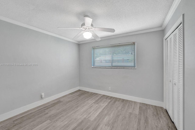 5031 SW 88th Ter, Cooper City, FL 33328 - unfurnished bedroom featuring a closet, wood finished floors, a textured ceiling, ornamental molding, and a ceiling fan