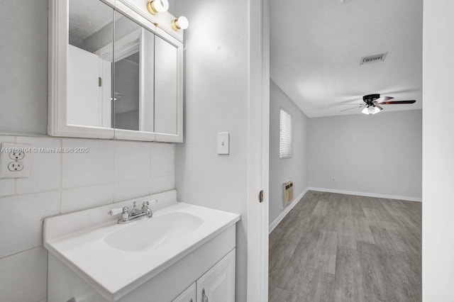 5031 SW 88th Ter, Cooper City, FL 33328 - bathroom featuring ceiling fan, vanity, wood finished floors, and backsplash